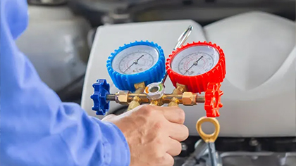 AC repair gauges being used on a vehicle, illustrating the diagnostic process for car air conditioning systems.